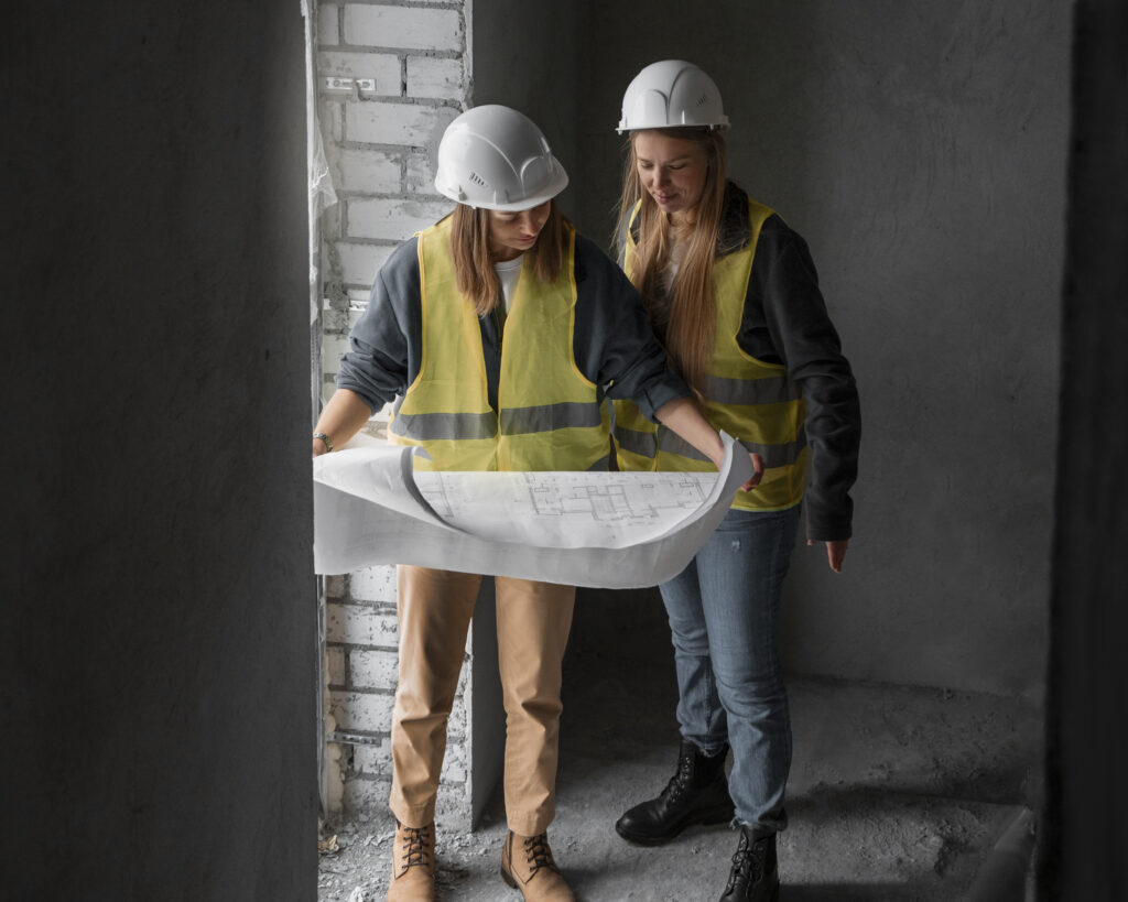 two women in construction read plans